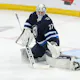 Connor Hellebuyck of the Winnipeg Jets makes a save as we look at the best 2024 Vezina Trophy odds.
