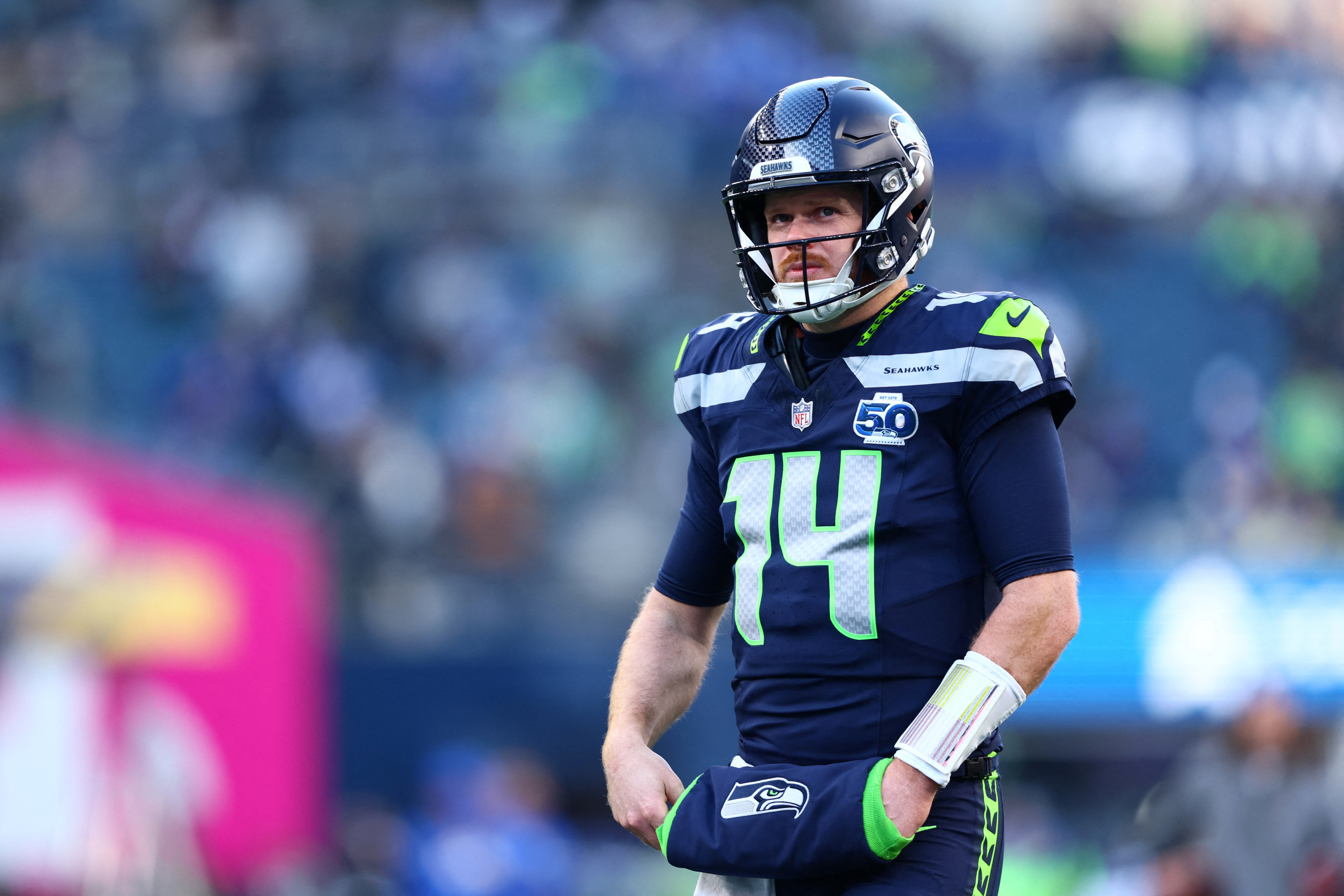 Seattle Seahawks quarterback Sam Darnold looks on as we offer a Sam Darnold injury update and examine the betting impact.