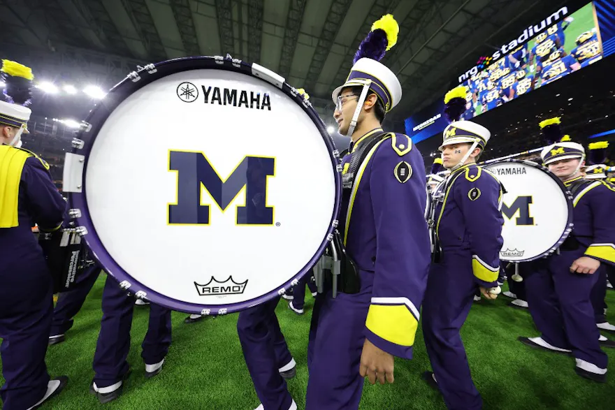 The Michigan Wolverines band on the field prior to the 2024 CFP National Championship game as we look at the best odds.