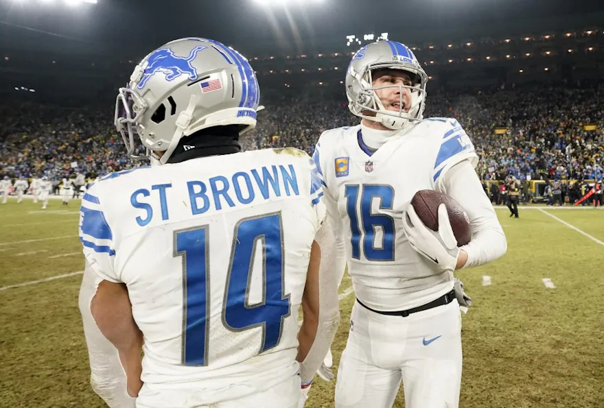 Jared Goff #16 and Amon-Ra St. Brown #14 of the Detroit Lions as we look at our Packers vs. Lions NFL player props for Thanksgiving