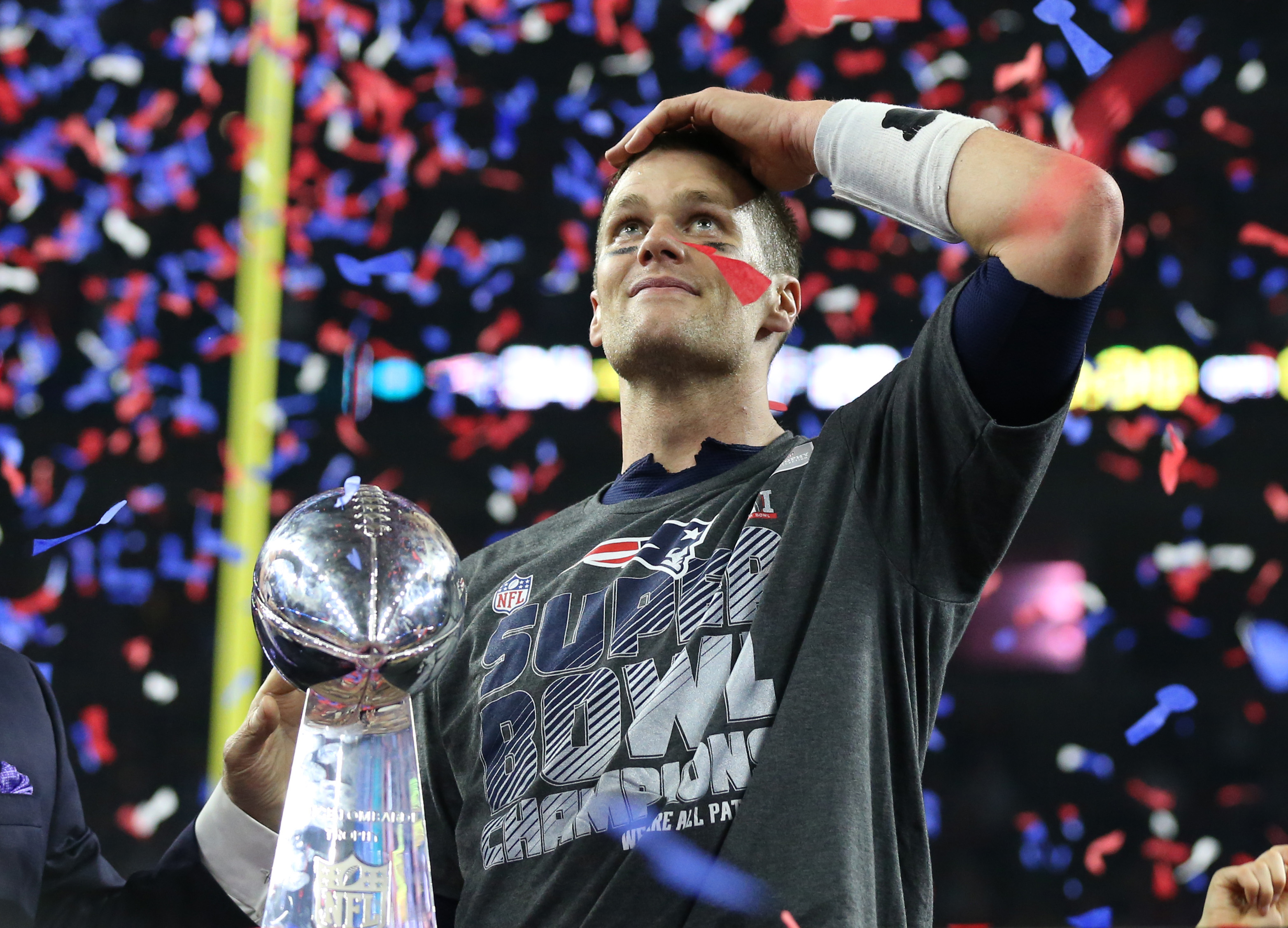 New England Patriots quarterback Tom Brady (12) celebrates with the Vince Lombardi Trophy after beating the Atlanta Falcons during Super Bowl LI at NRG Stadium.