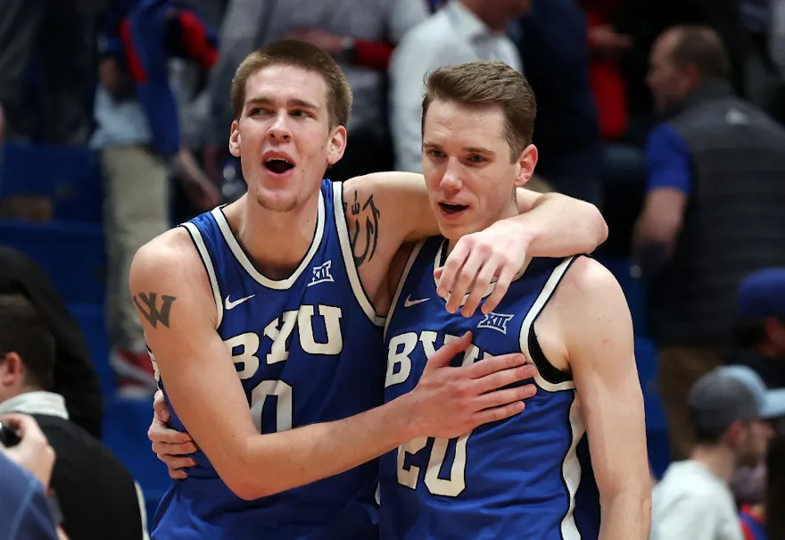 Noah Waterman and Spencer Johnson of the Brigham Young Cougars celebrate after defeating the Kansas Jayhawks, and we offer our top Duquesne vs. BYU prediction based on the best March Madness odds.