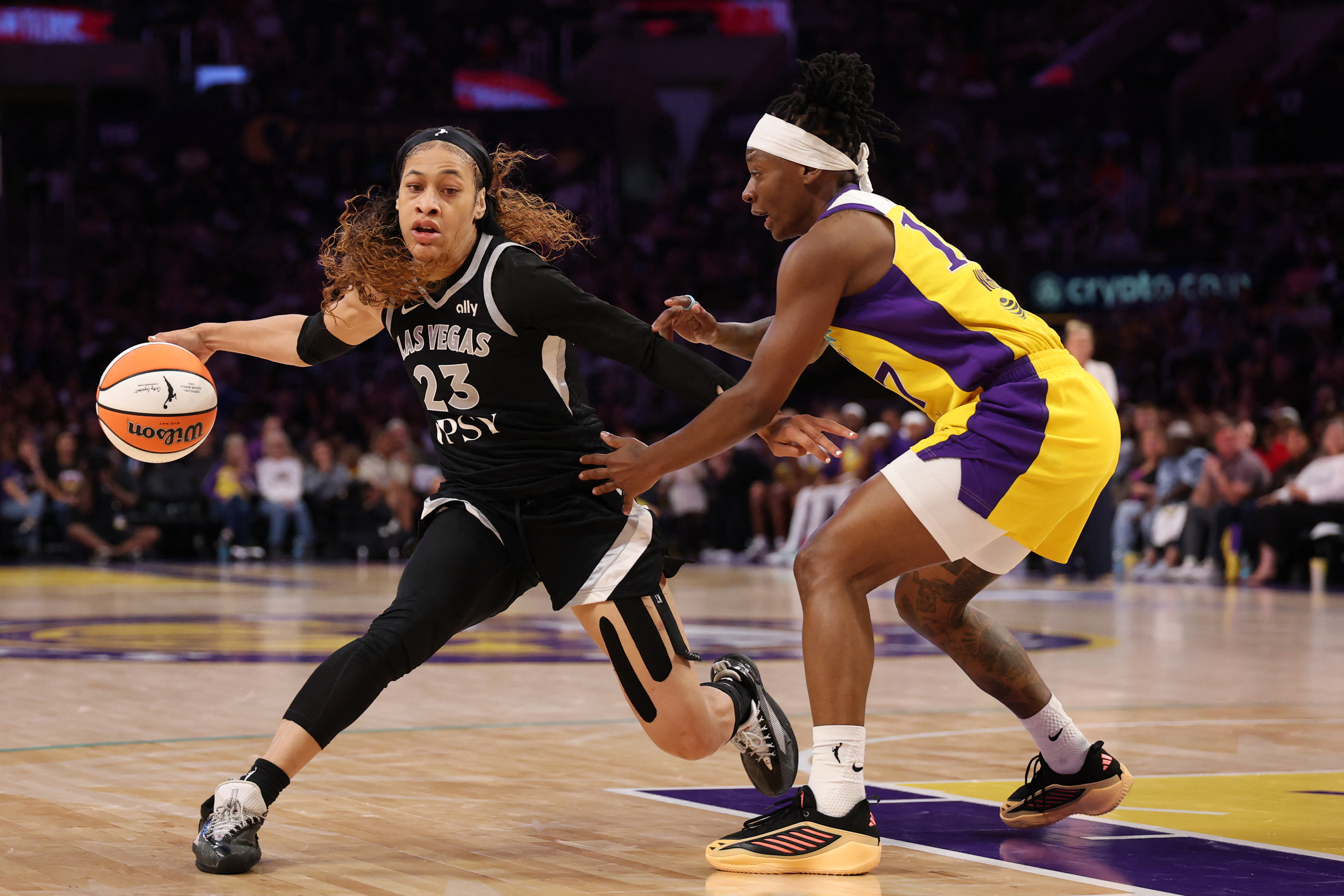 Las Vegas Aces guard Chennedy Carter (23), seen here dribbling the ball against Los Angeles Sparks guard Erica Wheeler (17), is featured in our Sparks vs. Aces prediction.
