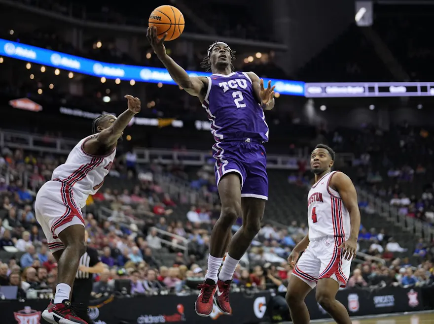 Emanuel Miller #2 of the TCU Horned Frogs shoots against Jamal Shead #1 and L.J. Cryer #4 of the Houston Cougars as we make our Utah State vs. TCU prediction for the March Madness Friday matchup. 