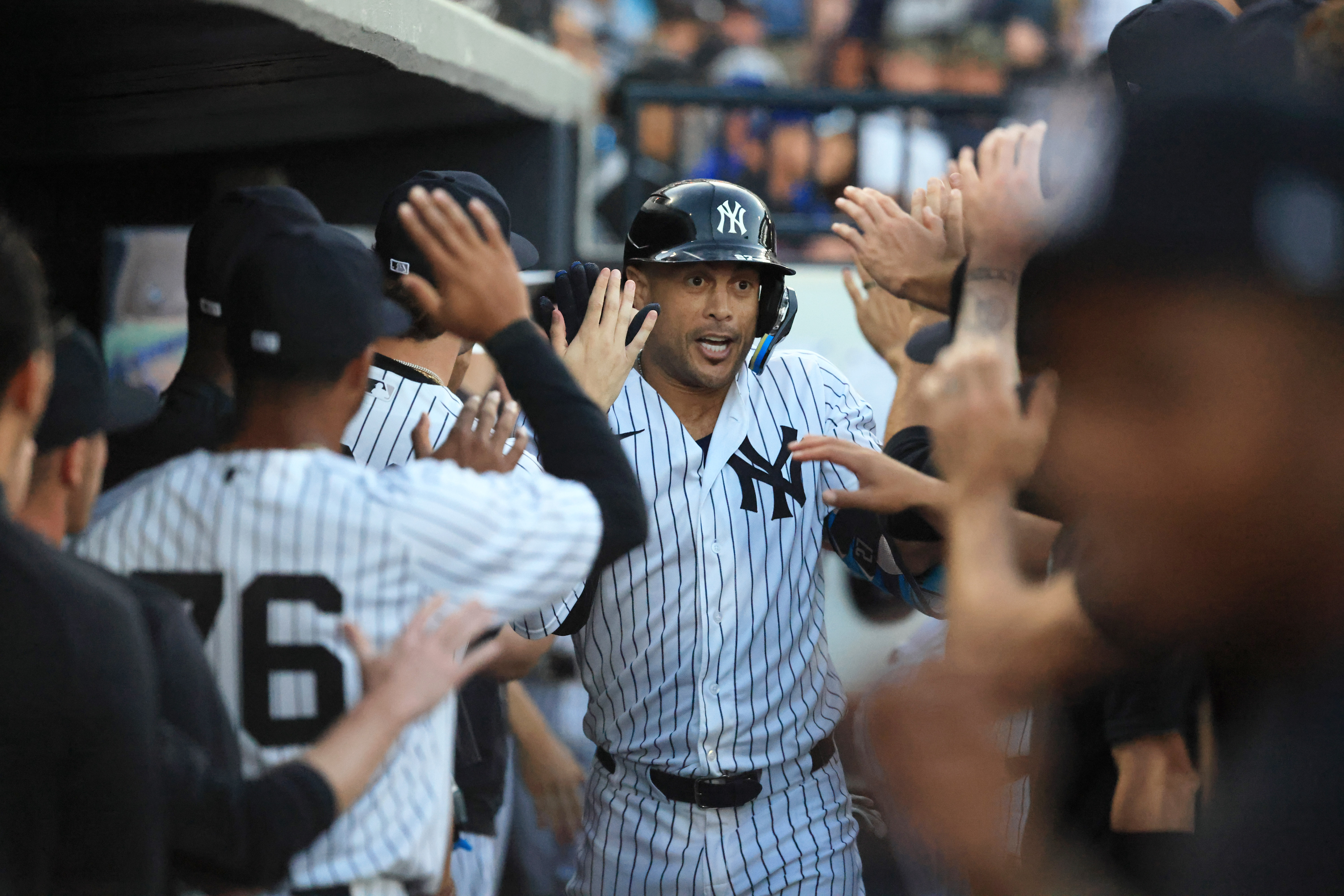 New York Yankees designated hitter Giancarlo Stanton - who's featured in my Yankees vs. Giants player props - is congratulated after hitting a 2-run home run.