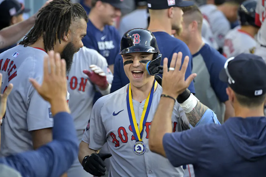 Boston Red Sox left fielder Tyler O'Neill is congratulated in the dugout after hitting his second two-run home run of the game in the seventh inning against the Los Angeles Dodgers at Dodger Stadium as we look at our MLB home run props for Tuesday.