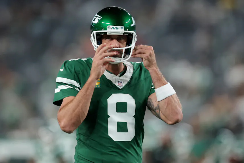 New York Jets quarterback Aaron Rodgers warms up before a game as we look at our Aaron Rodgers player prop bets.