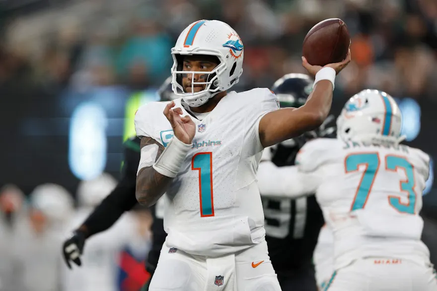 Tua Tagovailoa of the Miami Dolphins throws a pass ahead of our Week 13 NFL predictions for Dolphins vs. Commanders