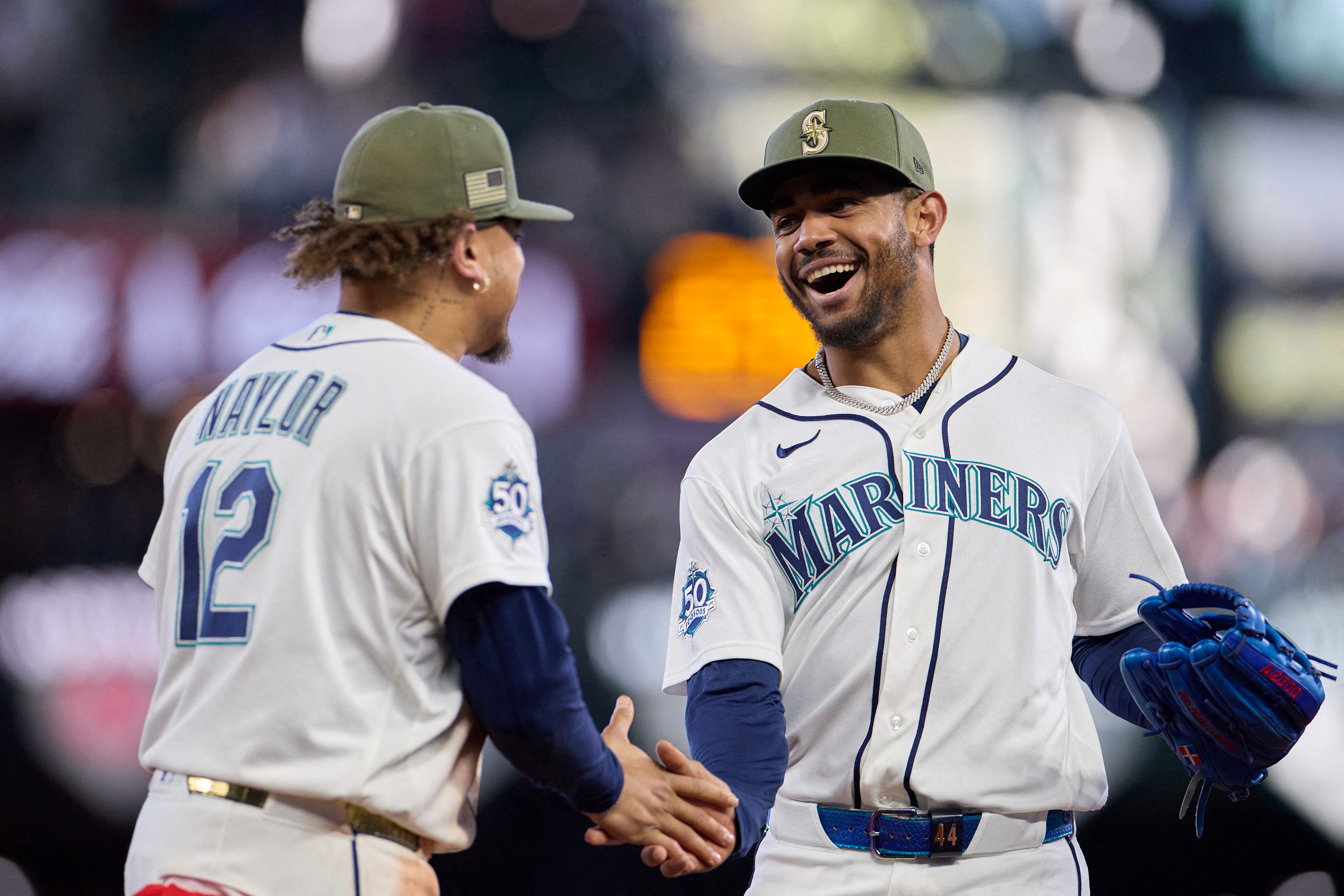 Seattle Mariners center fielder Julio Rodriguez celebrates after catching a fly ball, and he's key to our Padres vs. Mariners win probability.