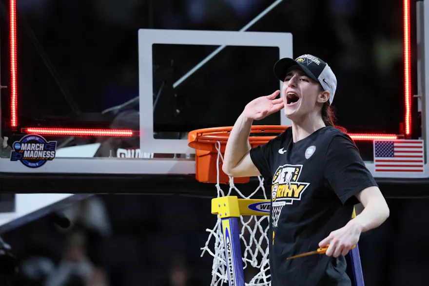 Caitlin Clark #22 of the Iowa Hawkeyes cuts down the net after beating the LSU Tigers in the Elite Eight of the NCAA Tournament. She'll face the UConn Huskies in the Final Four on Friday.