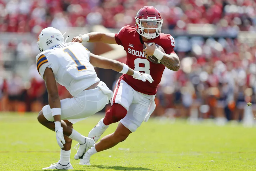 Dillon Gabriel of the Oklahoma Sooners cuts back past safety Tyson Wilson of the UTEP Miners to score a 12-yard touchdown.