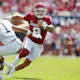 Dillon Gabriel of the Oklahoma Sooners cuts back past safety Tyson Wilson of the UTEP Miners to score a 12-yard touchdown.