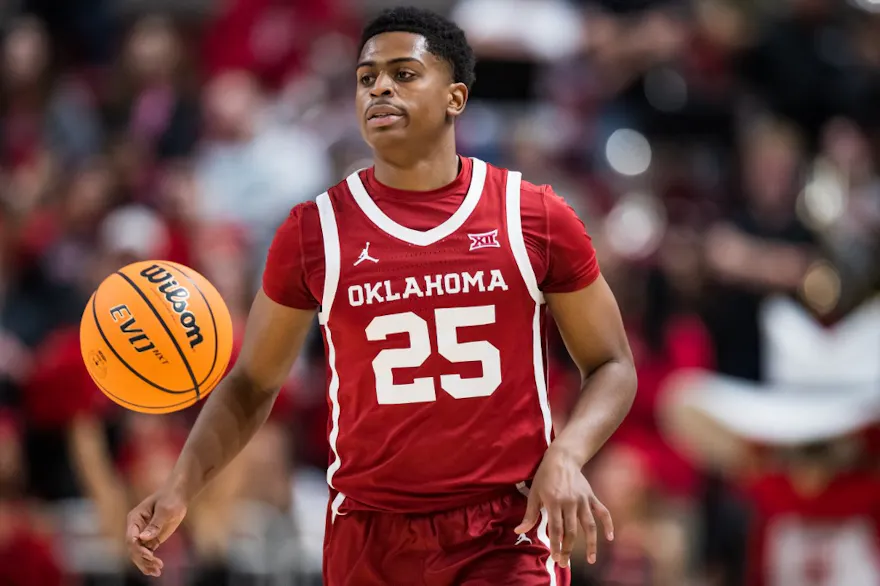 Guard Grant Sherfield of the Oklahoma Sooners handles the ball and we offer our top odds and picks for Oklahoma vs. Oklahoma State.