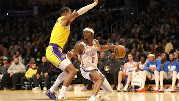Shai Gilgeous-Alexander of the Oklahoma City Thunder handles the ball against Troy Brown Jr. of the L.A. Lakers at Crypto.com Arena on Feb. 7, 2023 in Los Angeles, California.