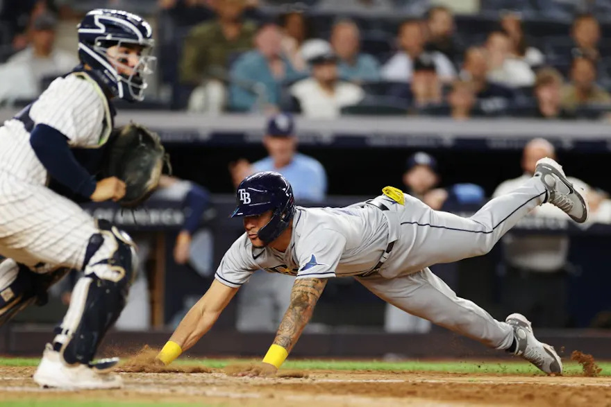 Jose Siri #22 of the Tampa Bay Rays slides into home to score during the ninth inning against the New York Yankees at Yankee Stadium on Aug. 15.