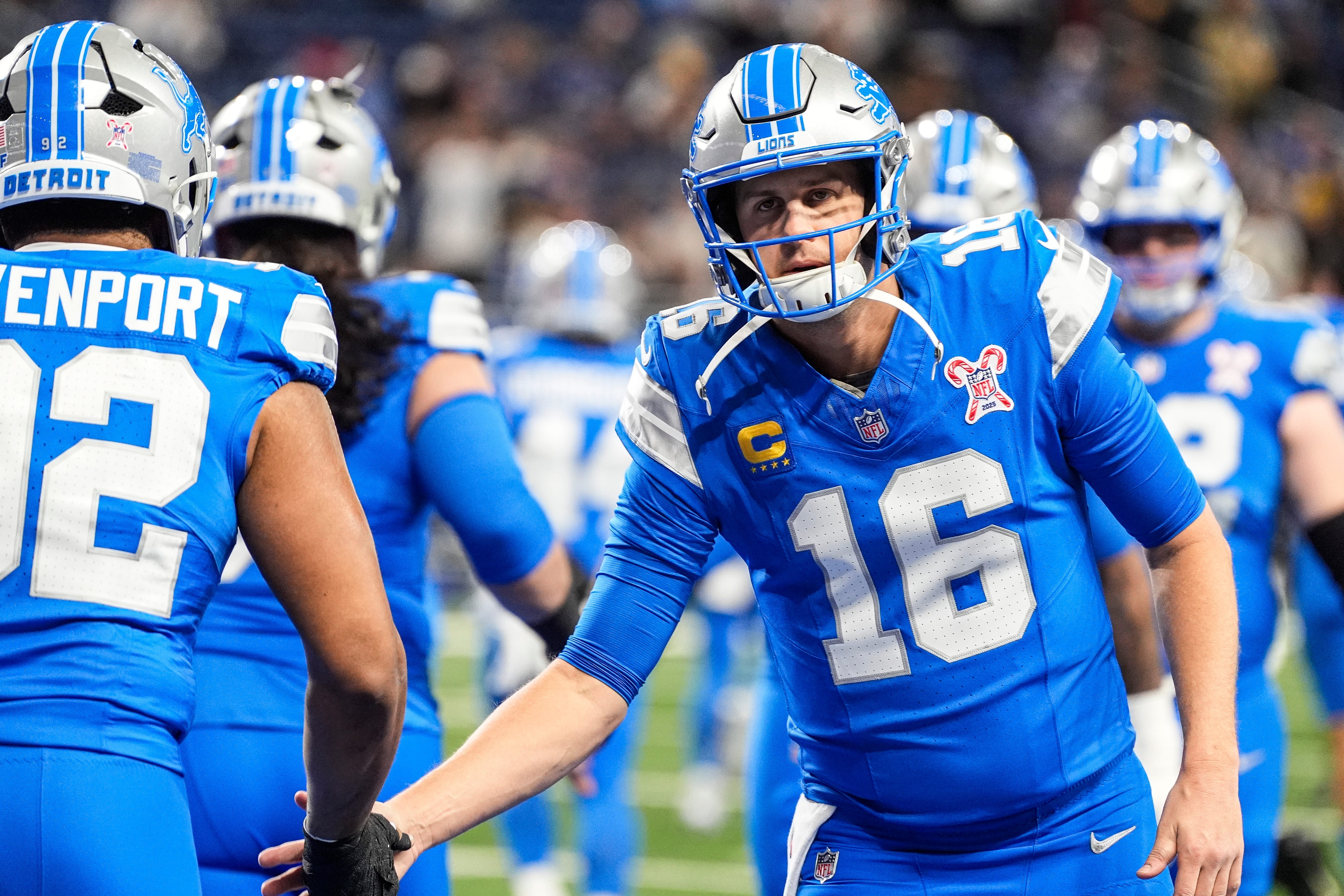 Detroit Lions quarterback Jared Goff (16) high-fives teammates as we offer our Lions vs. Vikings predictions.