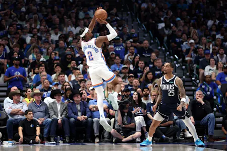 Shai Gilgeous-Alexander of the Oklahoma City Thunder shoots over P.J. Washington of the Dallas Mavericks during Game 3 of the NBA playoffs. We're backing Gilgeous-Alexander in our Thunder vs. Mavericks Player Props. 
