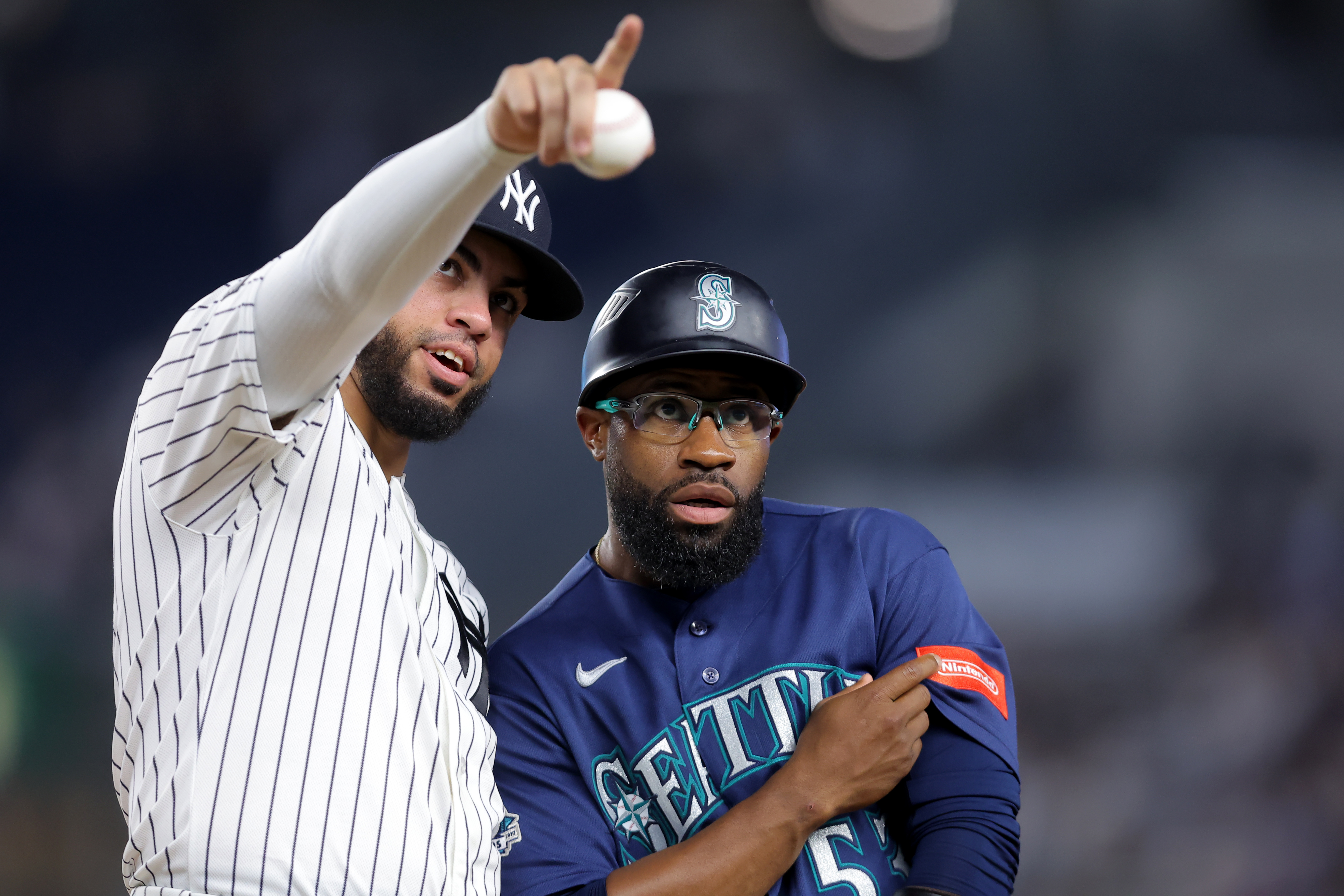 New York Yankees first baseman Luis Garcia Jr. talks to Seattle Mariners first base coach Eric Young Jr. as we make our best Mariners vs. Yankees prediction