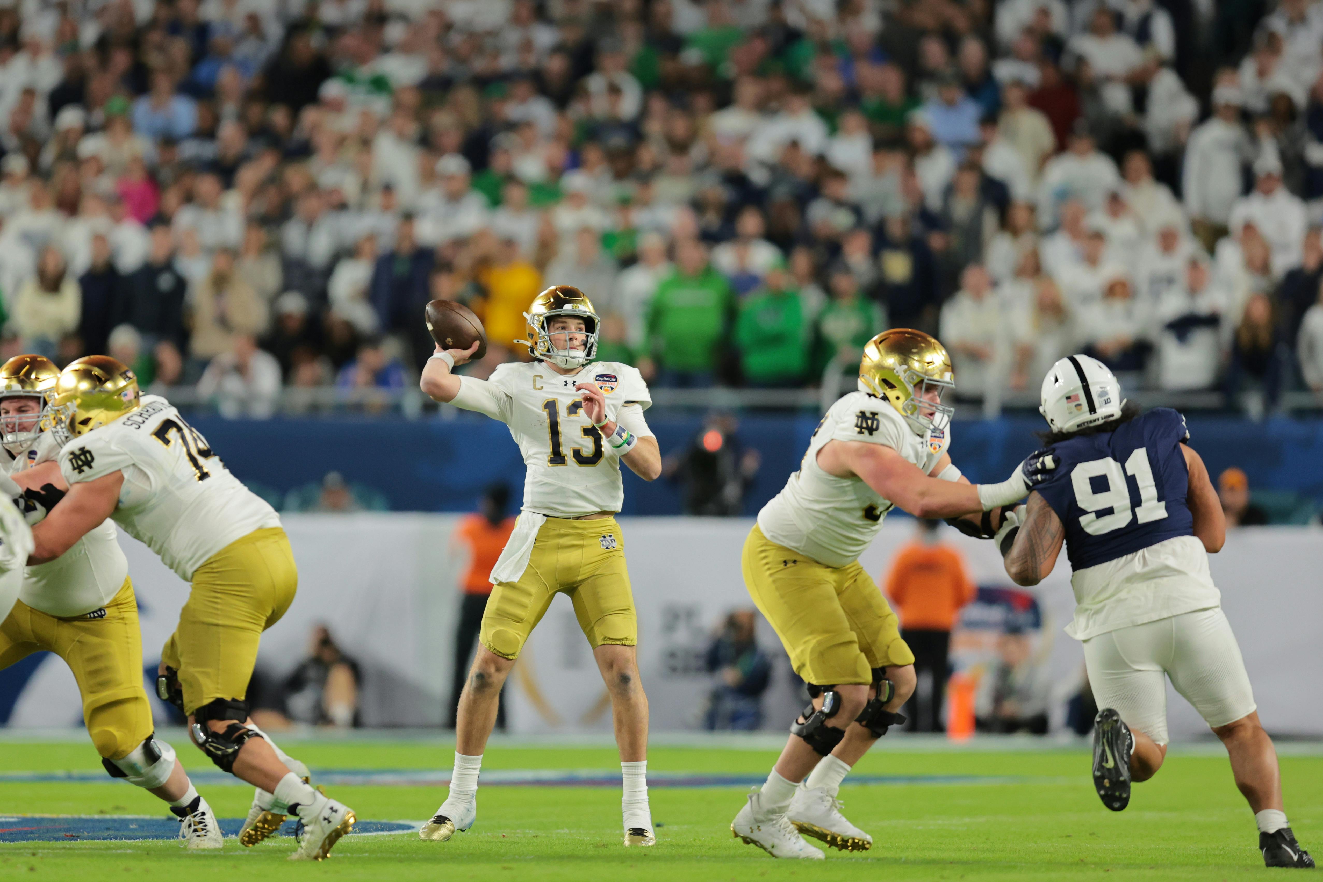 Notre Dame quarterback Riley Leonard throws a pass against Penn State. The Fighting Irish are underdogs to the Buckeyes by the College Football Playoff odds.