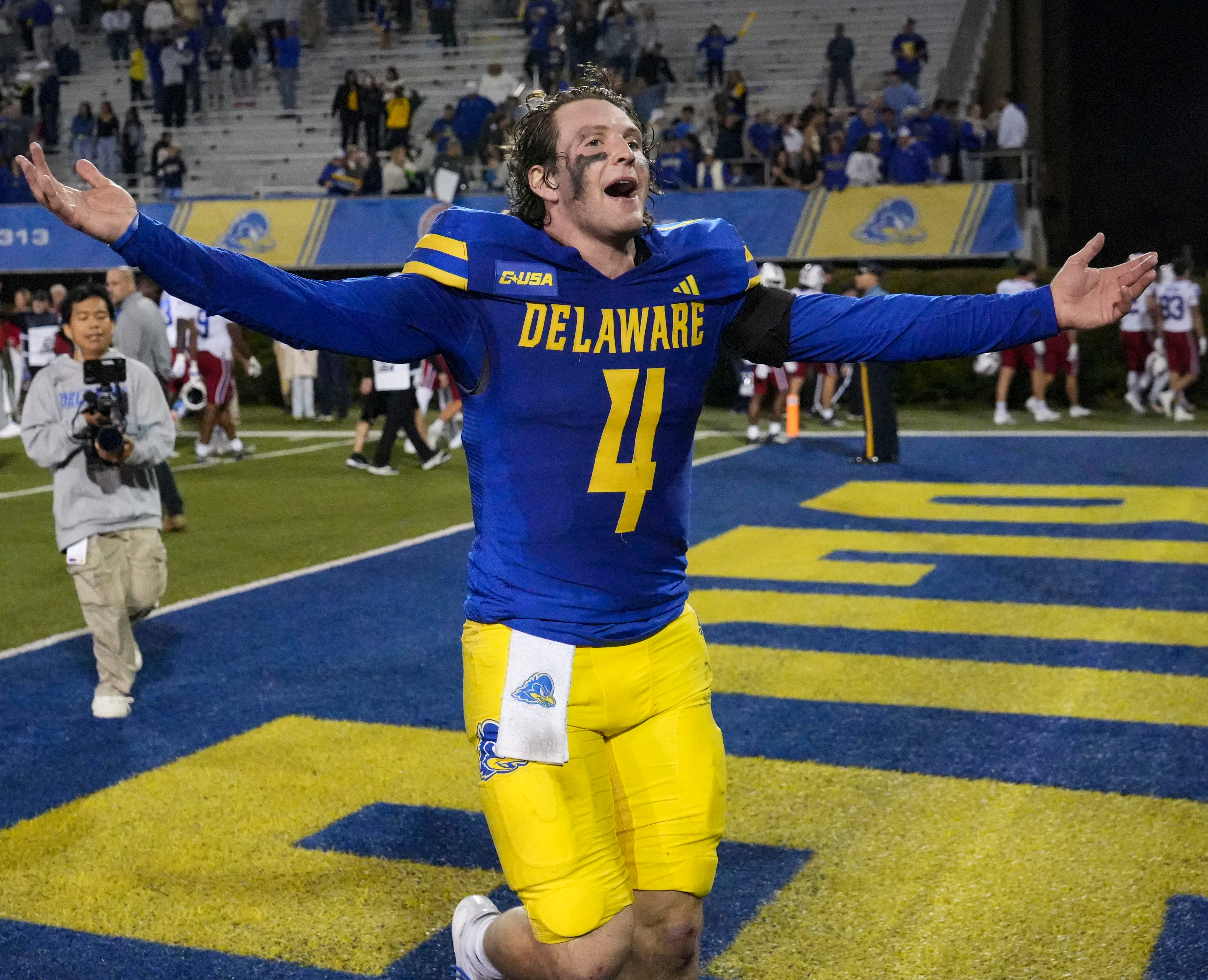 Delaware quarterback Nick Minicucci celebrates after the Blue Hens’ win as we look at the college football bowl game odds