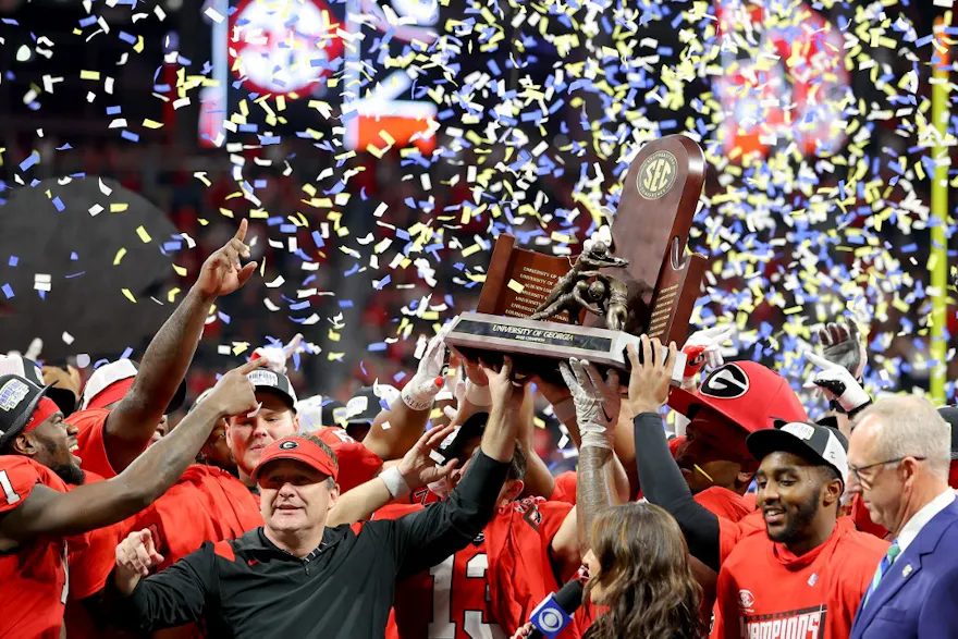 Head coach Kirby Smart of the Georgia Bulldogs celebrate with the trophy after defeating the LSU Tigers in the SEC Championship game at Mercedes-Benz Stadium in Atlanta, Georgia. Kevin C. Cox/Getty Images via AFP.