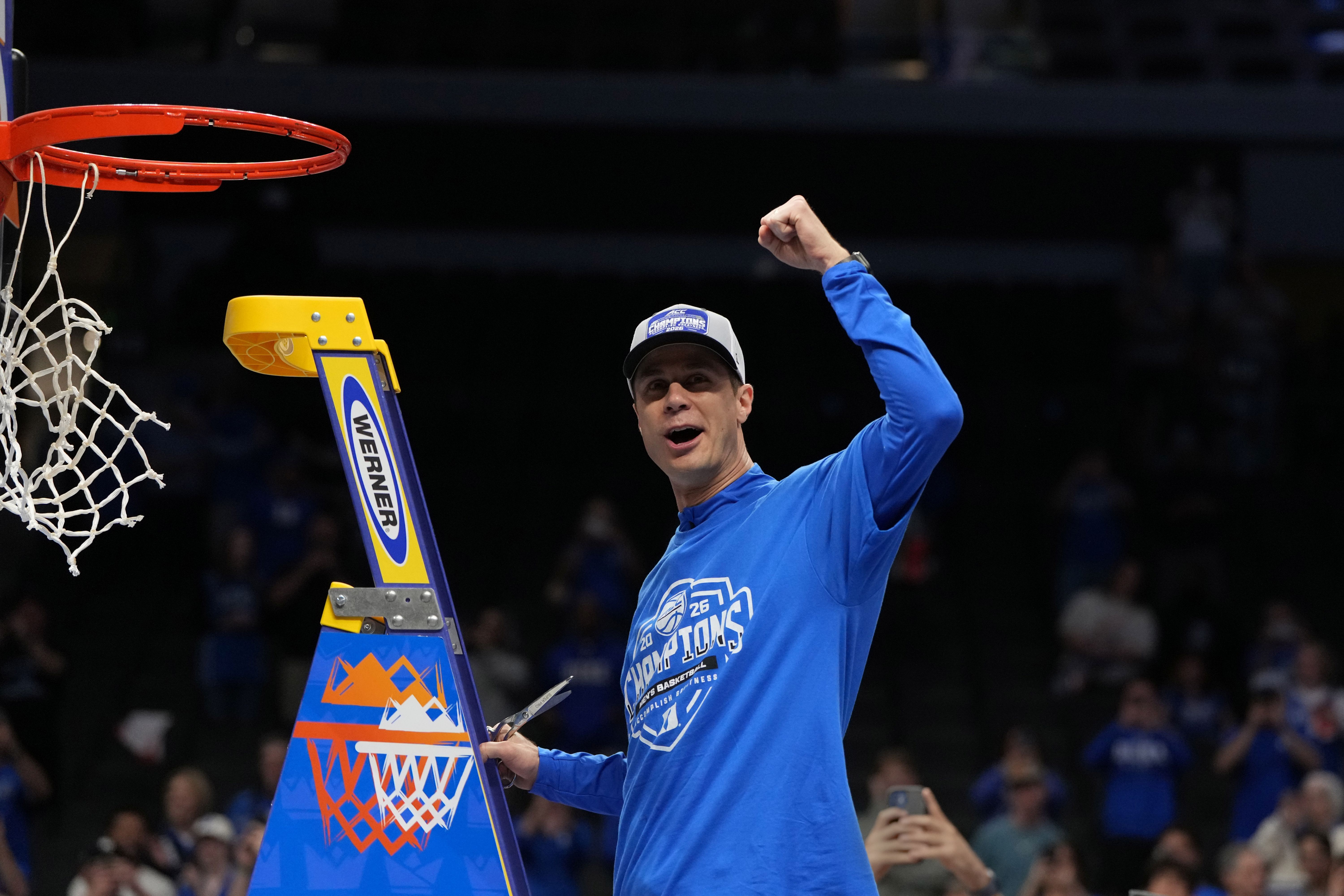 Duke Blue Devils head coach Jon Scheyer cuts down the net as we look at Duke trading as the favorite on Kalshi ahead of March Madness.