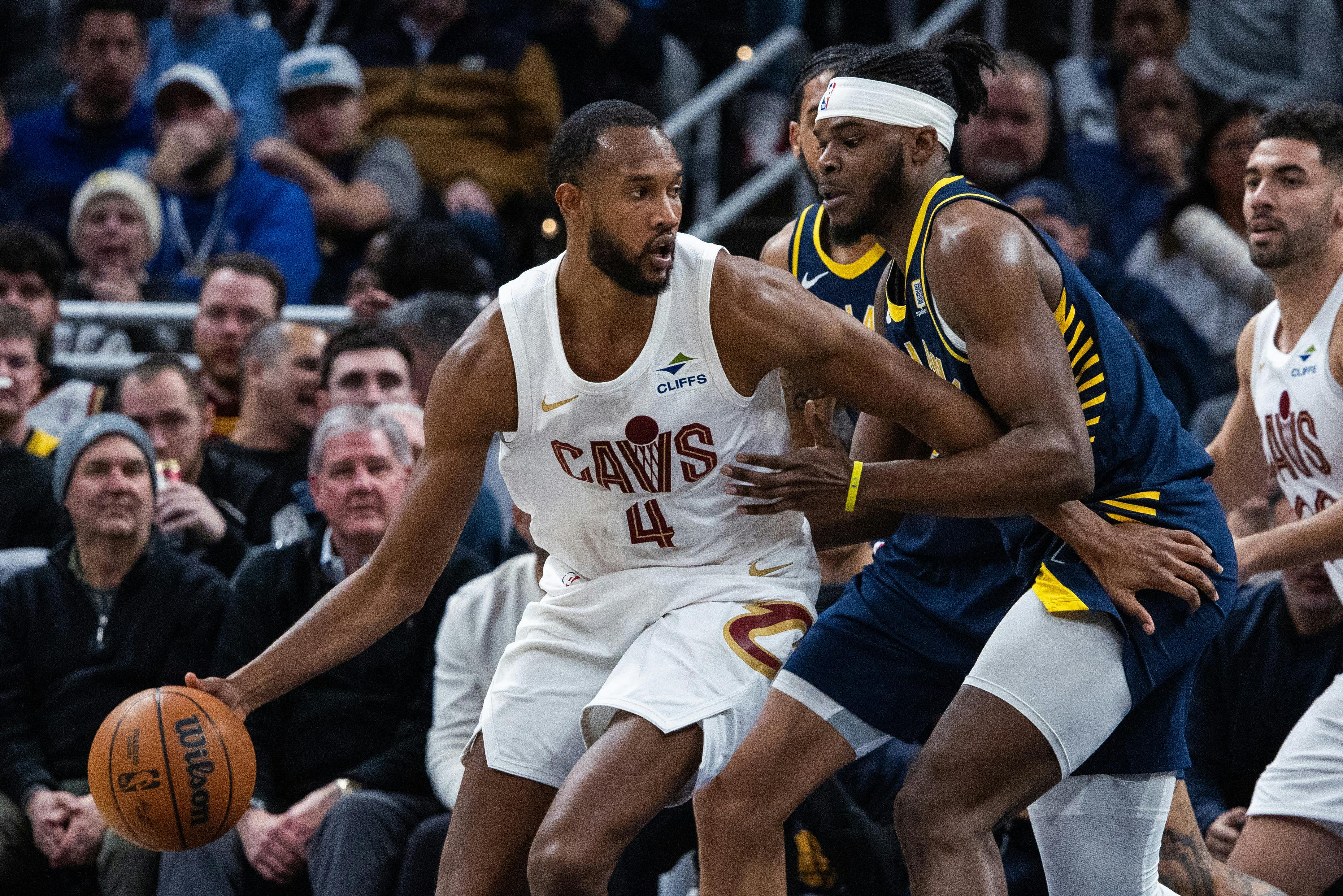 Cleveland Cavaliers forward Evan Mobley dribbles the ball against Indiana Pacers forward Jarace Walker. Mobley is among the NBA Most Improved Player odds contenders.