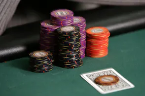 A player's chips and cards await a bet during a poker tournament as we look at the online poker scene in West Virginia.