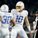 Austin Ekeler of the Los Angeles Chargers celebrates with teammate Justin Herbert after rushes for a touchdown against the Jacksonville Jaguars, and we offer new U.S. bettors our exclusive BetMGM bonus code for Bears vs. Chargers.