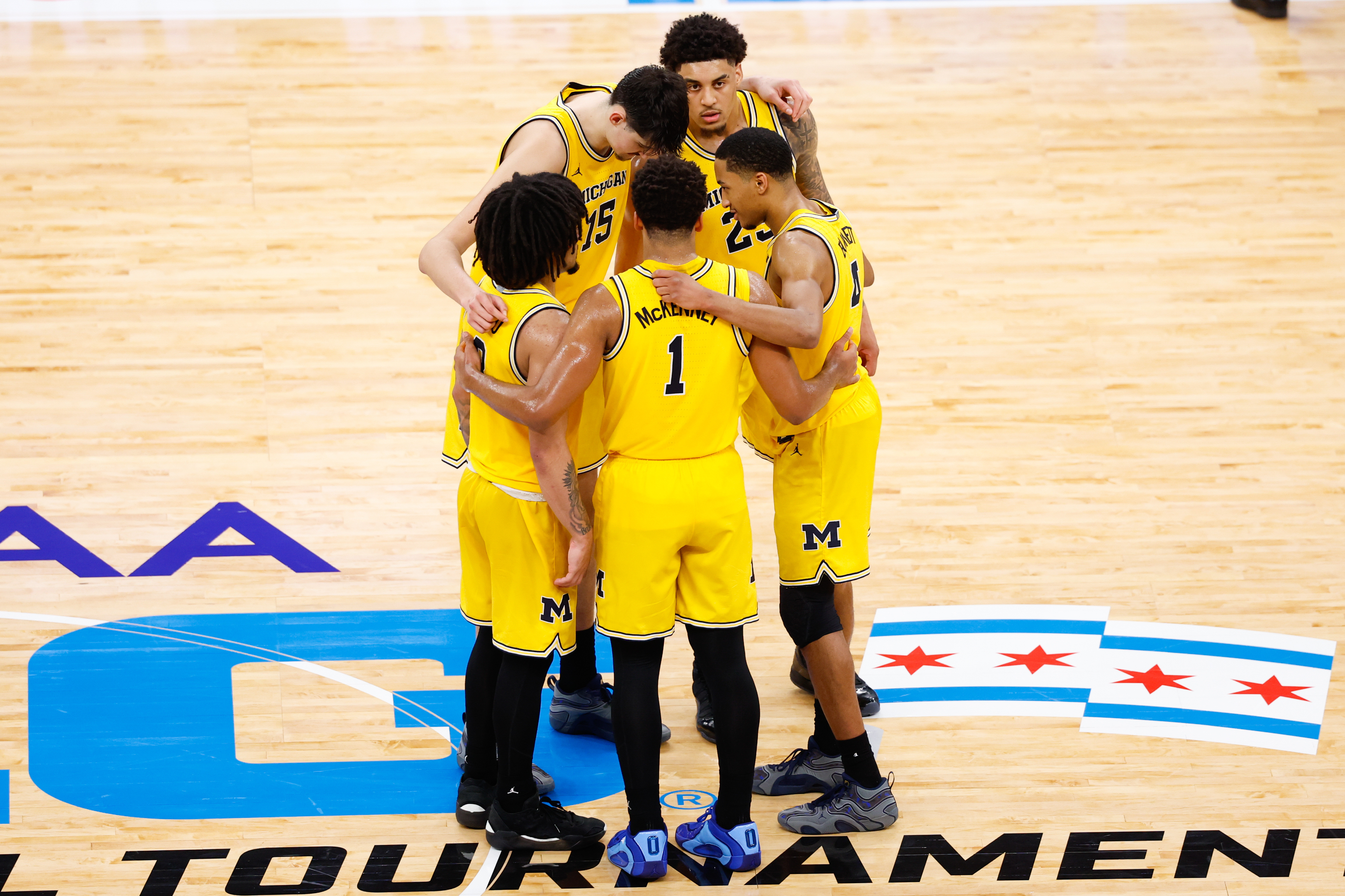 Michigan players huddle at halfcourt at we look at the March Madness odds