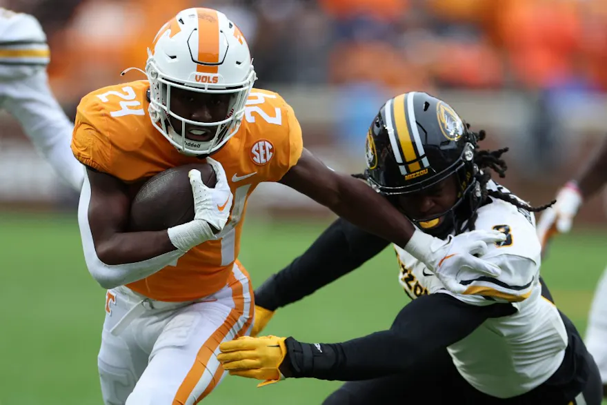 Dylan Sampson of the Tennessee Volunteers runs the ball with Ty'Ron Hopper of the Missouri Tigers defending. 