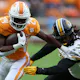 Dylan Sampson of the Tennessee Volunteers runs the ball with Ty'Ron Hopper of the Missouri Tigers defending. 