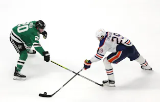 Ryan Suter of the Dallas Stars defends Leon Draisaitl of the Edmonton Oilers during overtime in Game 1 of the Western Conference Final of the 2024 Stanley Cup Playoffs. We're backing Draisaitl in our Stars vs. Oilers Predictions. 