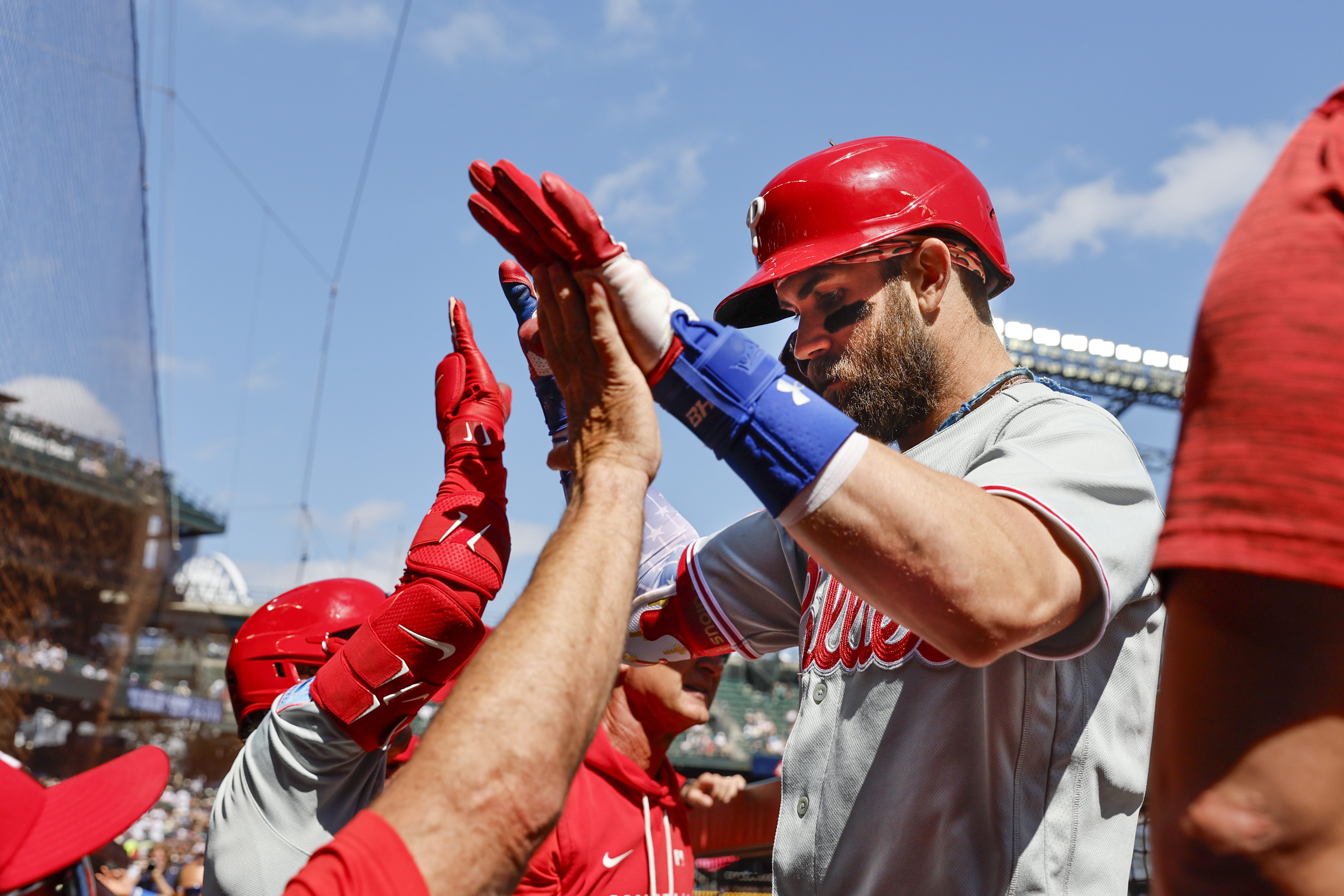 Philadelphia Phillies right fielder Bryce Harper (3) high fives teammates in the dugout following a two-run home run against the Seattle Mariners during the first inning at T-Mobile Park.