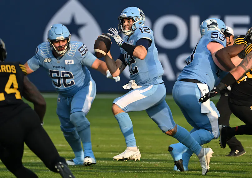 Toronto Argonauts quarterback Chad Kelly runs with the ball against the Hamilton Tiger-Cats. We're expecting plenty of points in our Argonauts vs. Lions prediction.