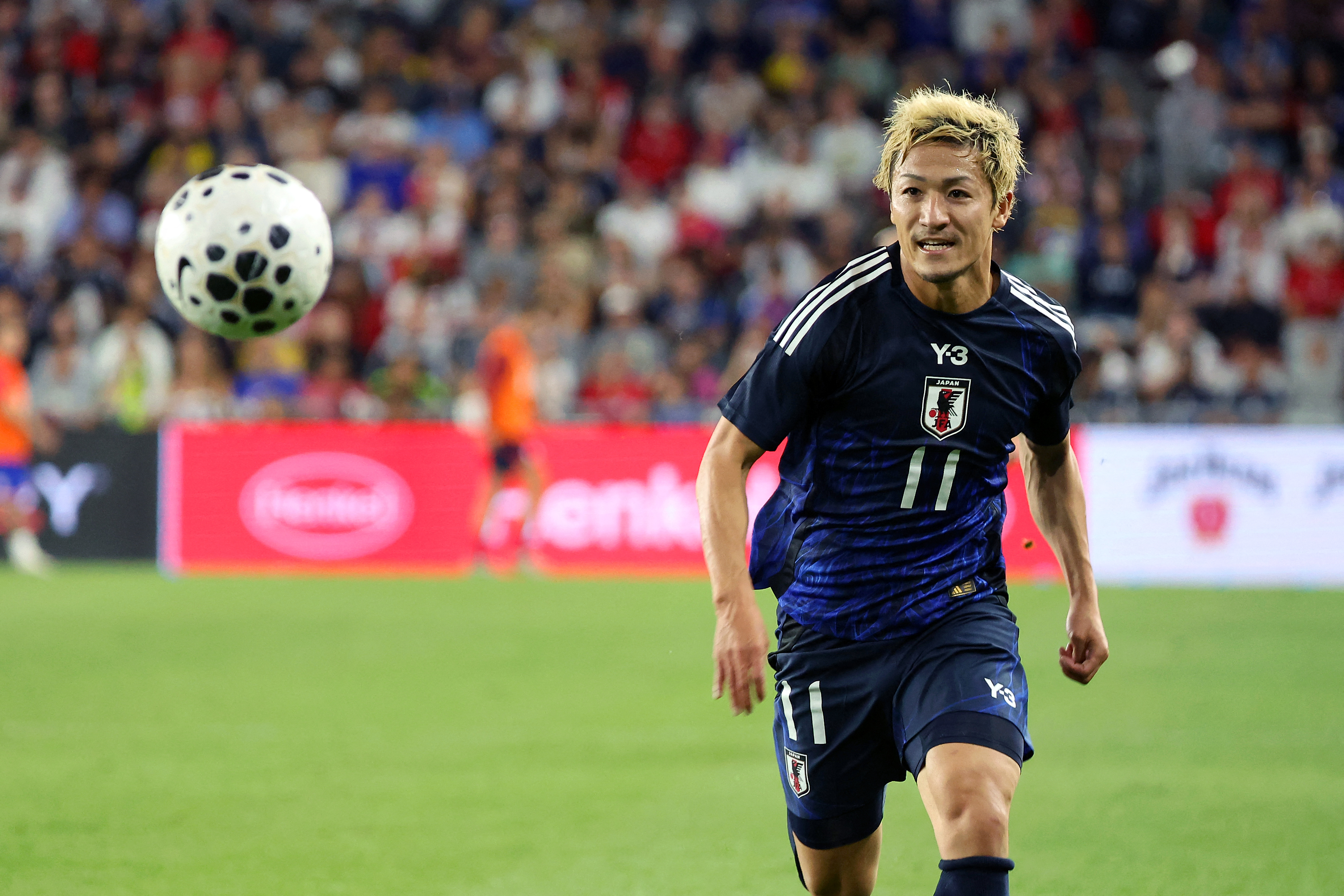 Japan forward Daizen Maeda (11) chases the ball as we break down our Tunisia vs. Japan prediction.