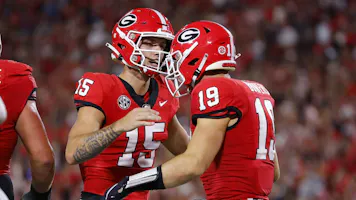 Brock Bowers of the Georgia Bulldogs scores a touchdown and reacts with Carson Beck as we make our favorite Alabama-Georgia prediction in the SEC Championship Game.