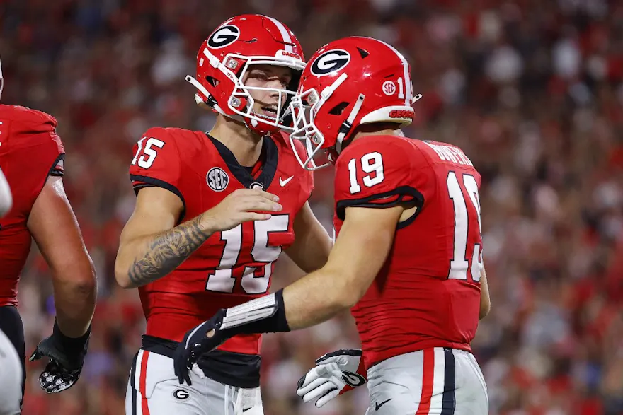 Brock Bowers of the Georgia Bulldogs scores a touchdown and reacts with Carson Beck as we look at the latest resolution passed by the Georgia Senate regarding sports betting.