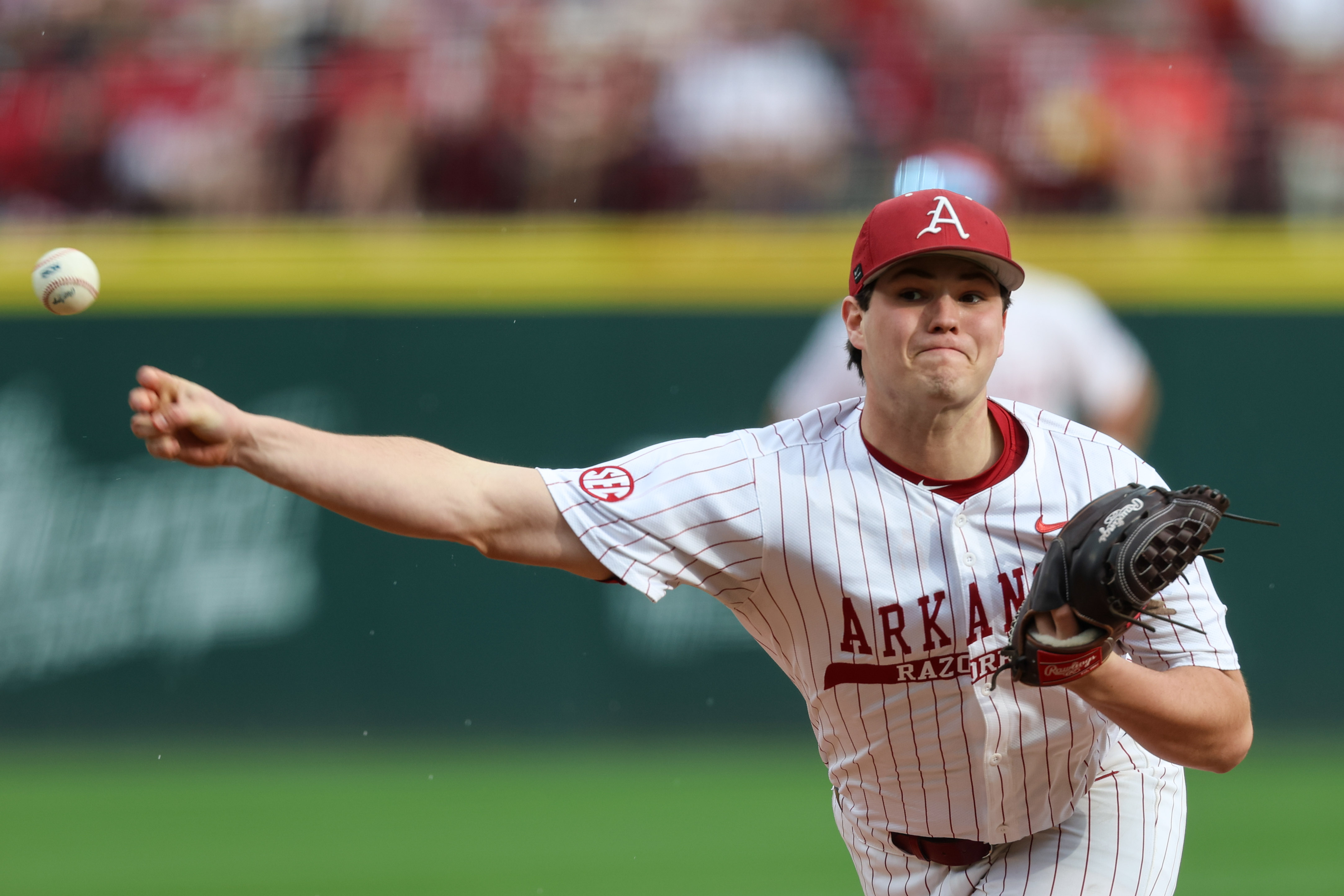 Arkansas pitcher Mark Brissey releases the ball as we look at DraftKings and FanDuel approval in Arkansas.