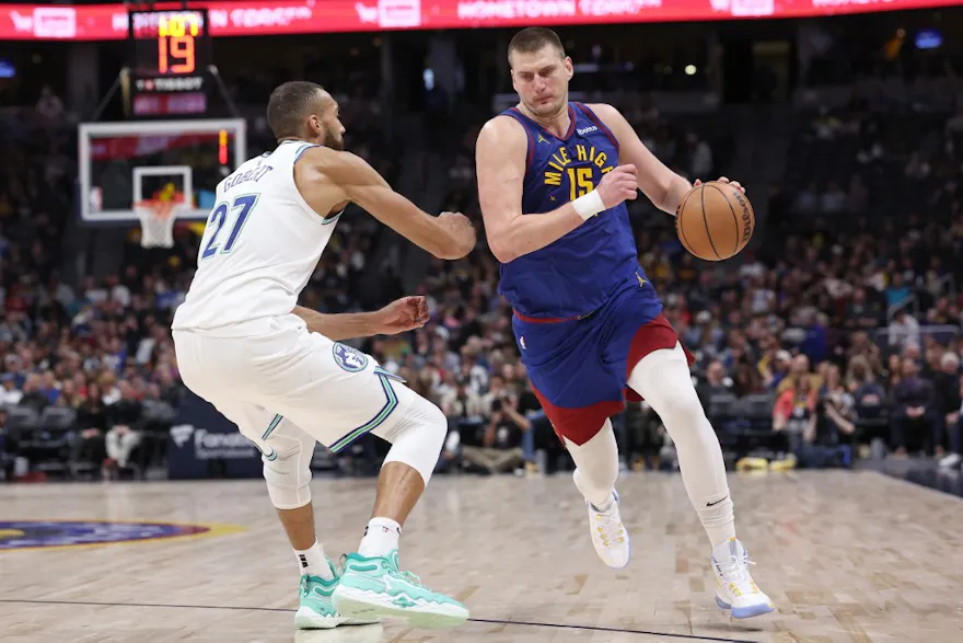 Nikola Jokic #15 of the Denver Nuggets drives against Rudy Gobert #27 of the Minnesota Timberwolves as we offer our best Timberwolves vs. Nuggets player props and predictions for Wednesday's NBA contest.