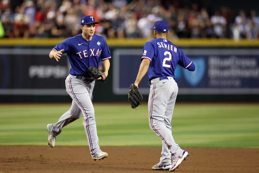 Corey Seager #5 and Marcus Semien #2 of the Texas Rangers celebrate as we make our Rangers-Diamondbacks World Series Game 4 prediction.