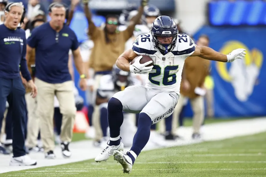 Zach Charbonnet of the Seattle Seahawks runs with the ball as we make our best Eagles vs. Seahawks prop picks.