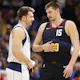 Luka Doncic #77 of the Dallas Mavericks (L) and Nikola Jokic #15 of the Denver Nuggets talk as we look at the latest NBA MVP odds.