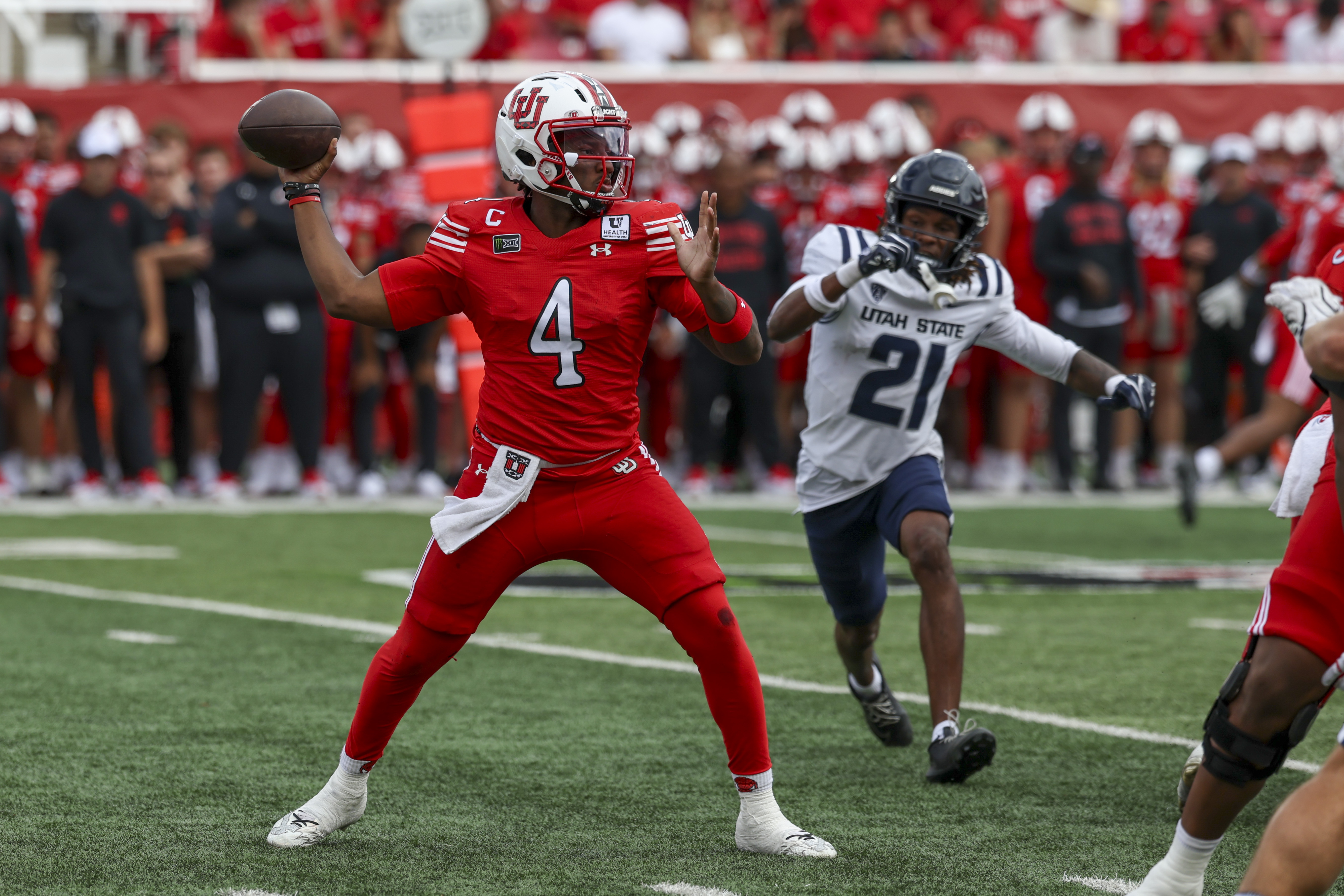 Pictured: Utes quarterback Devon Dampier throwing a pass as we break down our Kansas vs. Utah Prediction. Photo by Rob Gray-Imagn Images.