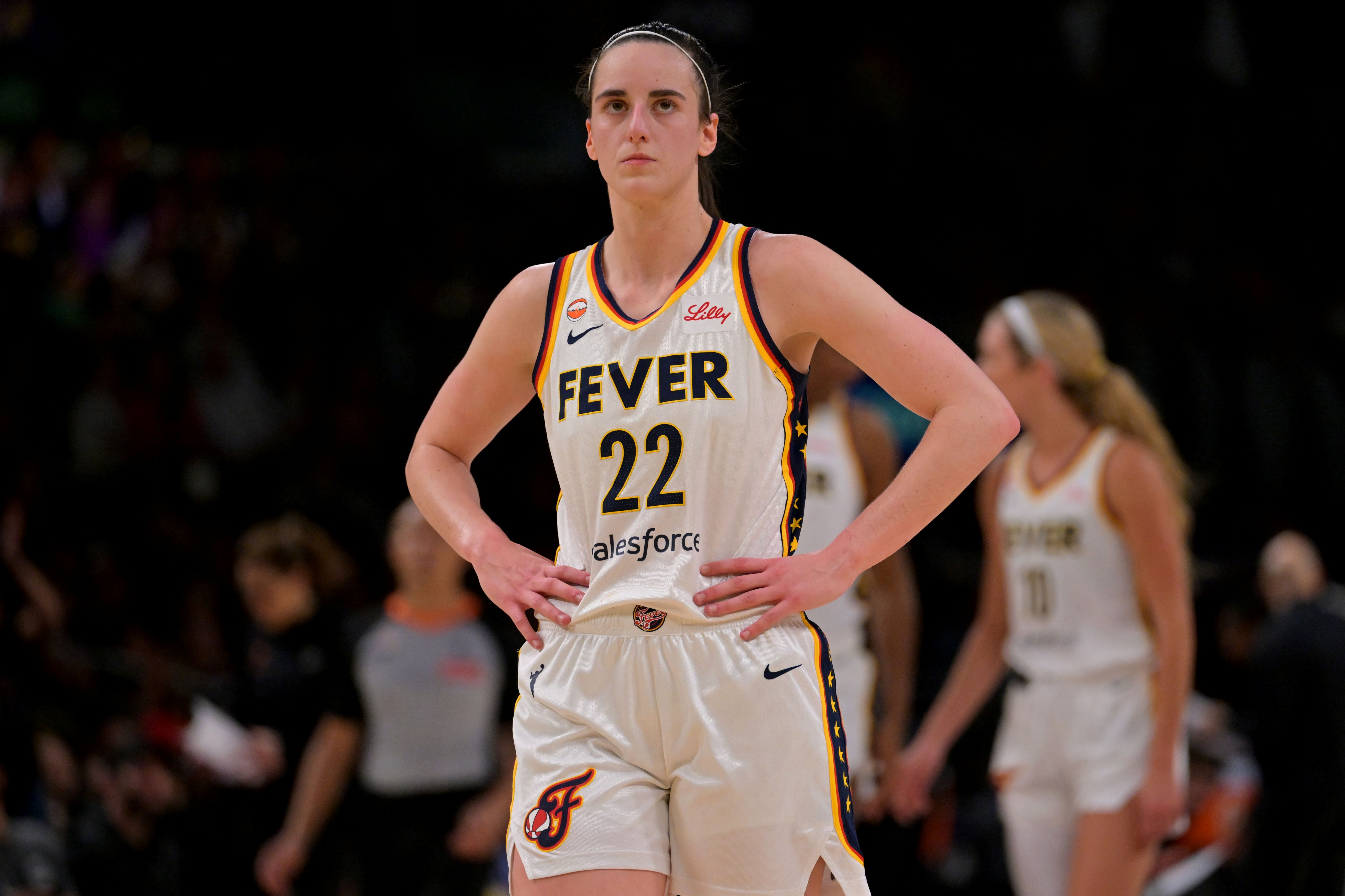 Indiana Fever guard Caitlin Clark looks on, and she's featured as part of my Storm vs. Fever prediction.