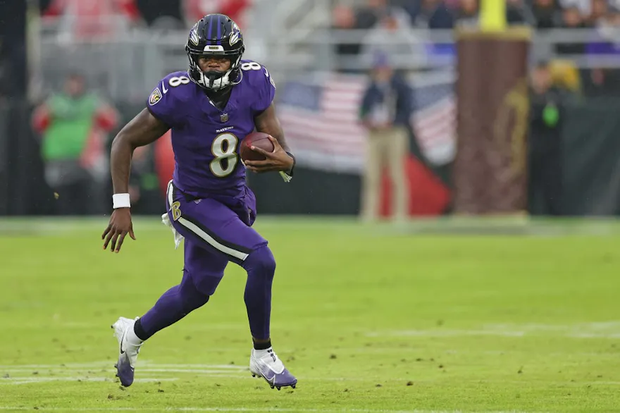 Lamar Jackson #8 of the Baltimore Ravens runs the ball as we make our Lamar Jackson NFL player props predictions and picks for Ravens vs. Jaguars in Week 15 on Sunday Night Football.