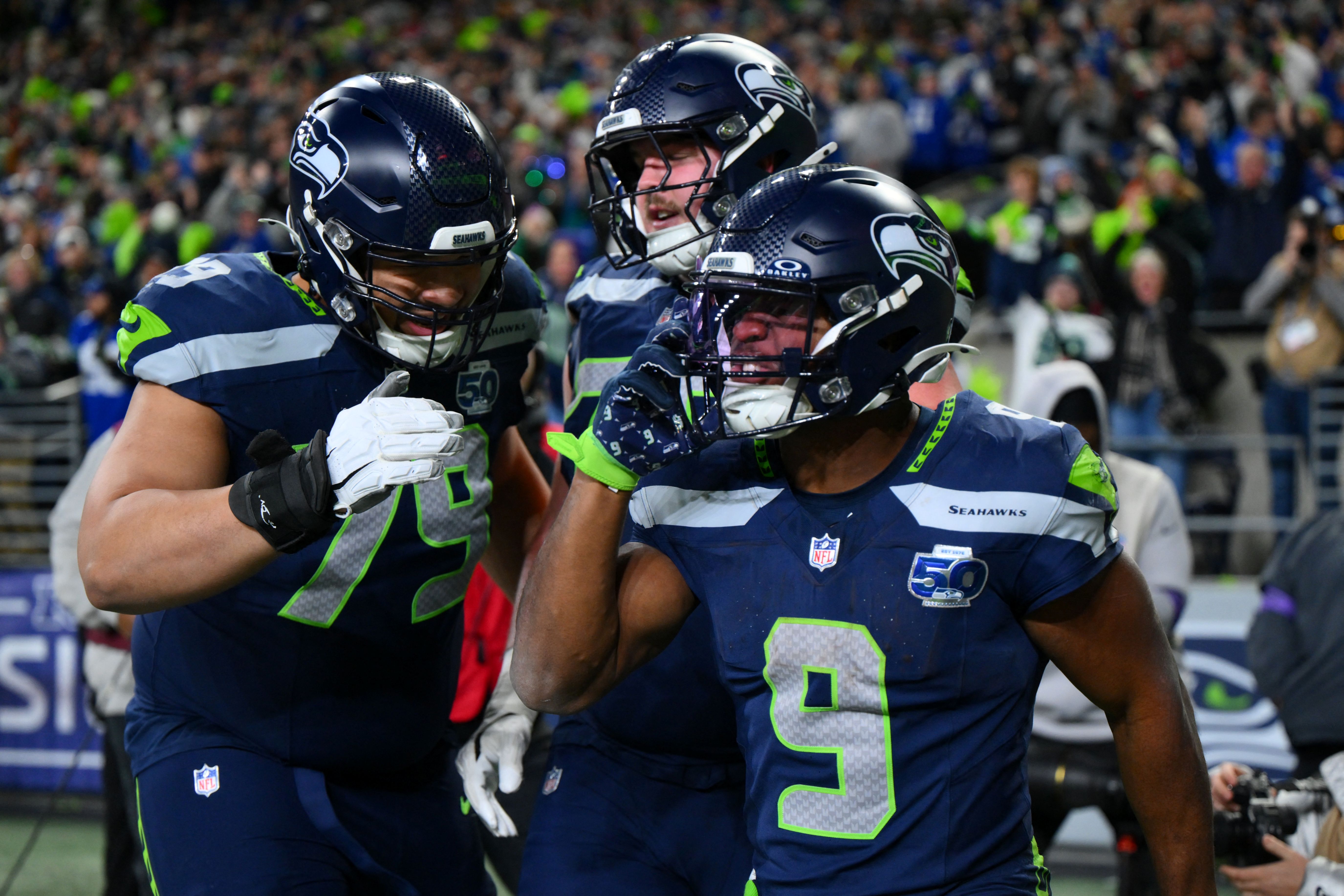 Seattle Seahawks running back Kenneth Walker III (9) reacts with teammates as we offer our Super Bowl predictions and ATS picks for Seahawks vs. Patriots.