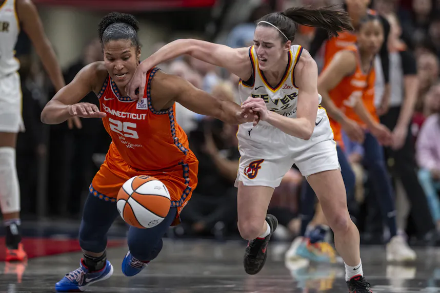 Connecticut Sun forward Alyssa Thomas knocks the ball away from Indiana Fever guard Caitlin Clark during the second half of an WNBA basketball game. We're backing Thomas in our Fever vs. Sun Prediction.