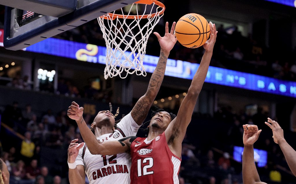 South Carolina Gamecocks' Zachary Davis and Arkansa Razorbacks' Tramon Mark reach for a rebound in the first half as as we make our Oregons vs. South Carolina March Madness prediction.