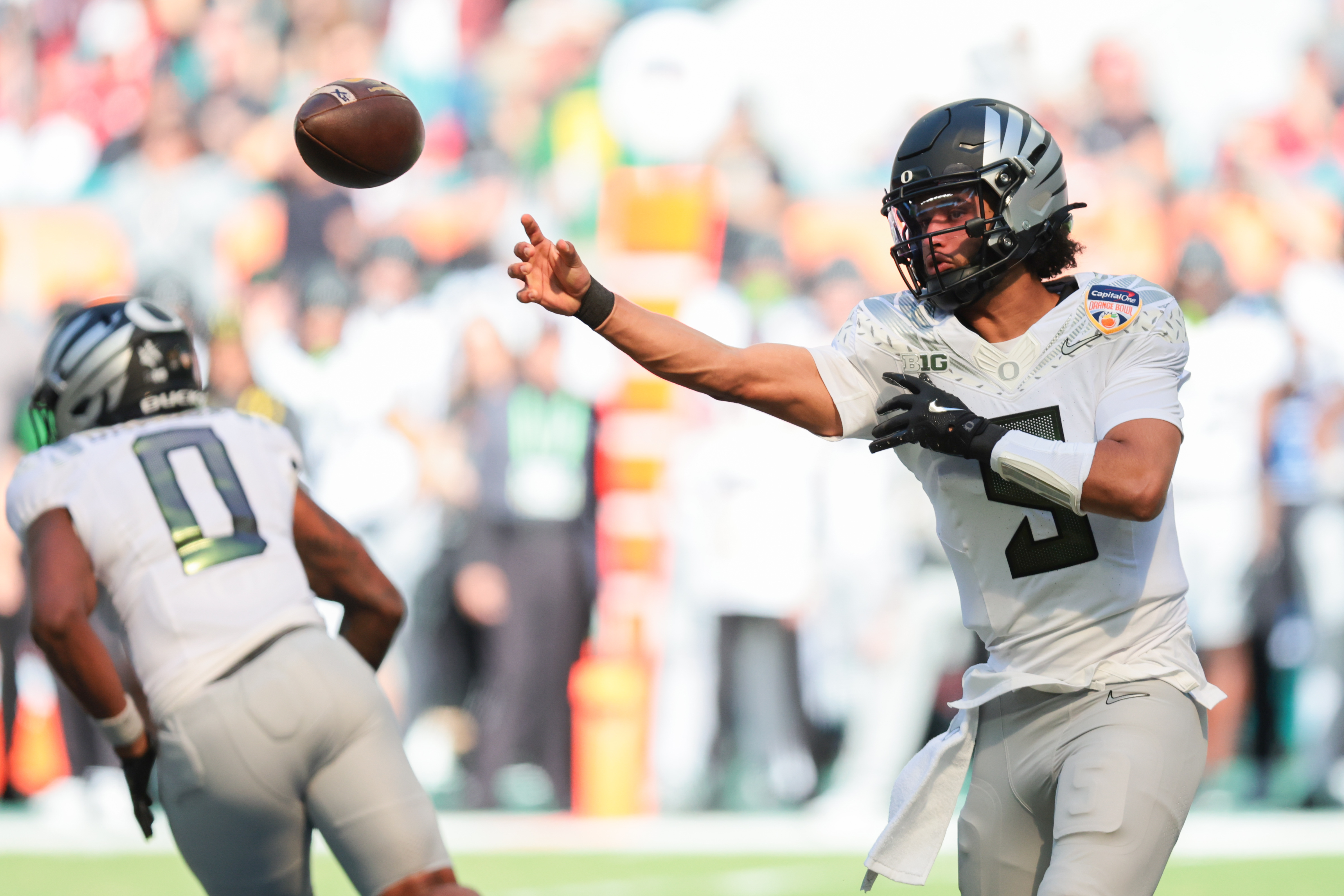 Oregon Ducks quarterback Dante Moore (5) passes the ball during as we break down our Dante Moore player prop picks.